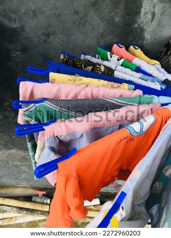Colorfull clothes while Drying during sunny day under the sunlight with traditional hanger