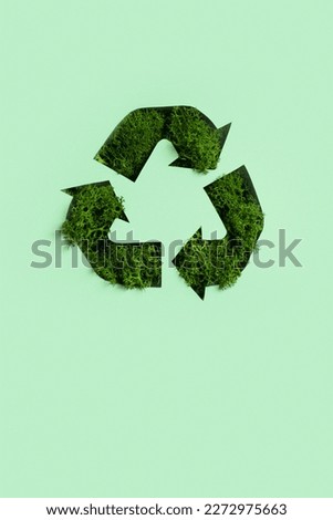 Green moss under paper cut recycling symbol. Save planet, eco, recycling concept. Royalty-Free Stock Photo #2272975663