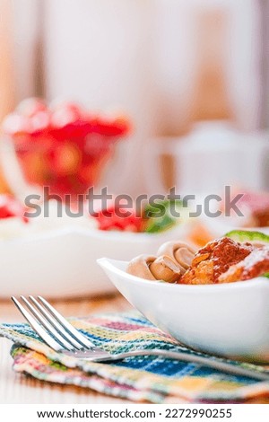 Plate of chicken and vegetables on a wooden table.