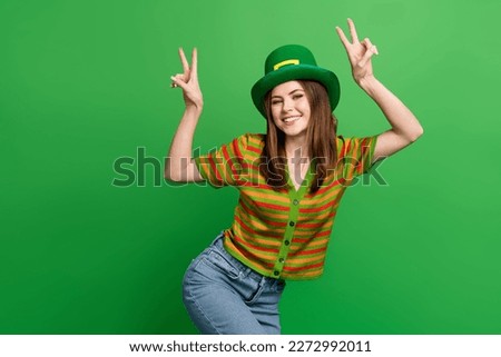 Photo of excited positive person toothy smile hands fingers demonstrate v-sign isolated on green color background