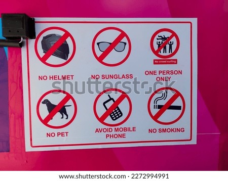 List of banned items on a notice board outside the entrance to the ATM