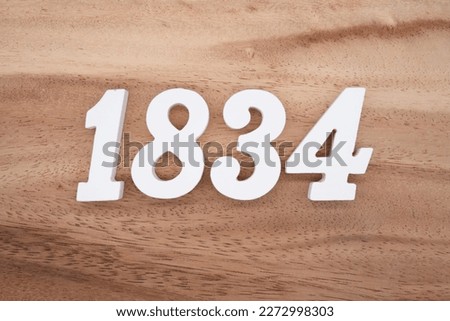 White number 1834 on a brown and light brown wooden background.