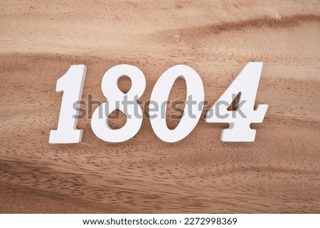 White number 1804 on a brown and light brown wooden background.