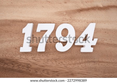 White number 1794 on a brown and light brown wooden background.