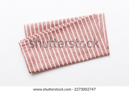 top view with red empty kitchen napkin isolated on table background. Folded cloth for mockup with copy space, Flat lay. Minimal style. Royalty-Free Stock Photo #2273002747
