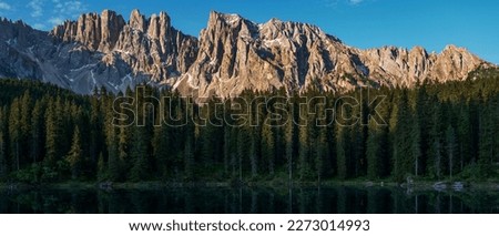 Incredible nature landscape. Sunny sammer day in Dolomites Alps. Lake Carezza with Mount Latemar, Bolzano province, South tyrol, Italy. popular travel locations. Picture of wild area.