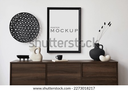 Creative composition of modern living room interior design with mock up poster frame, brown commode, vases, sculpture and personal accessories. White wall. Copy space. Template.
