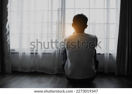 Sad young man in the bedroom, People with depression concept.
