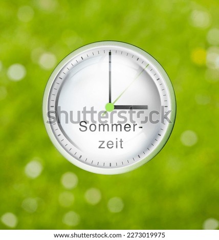 Dial with three clock to change time to daylight saving time in german letters Sommerzeit