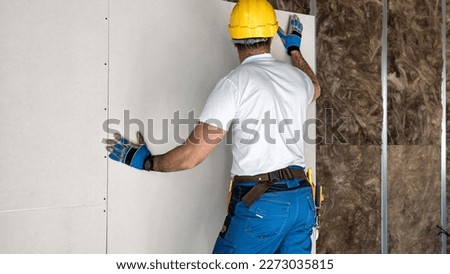 Installation of a plasterboard partition. Drywall system with acoustic insulation and sheet metal construction. Royalty-Free Stock Photo #2273035815