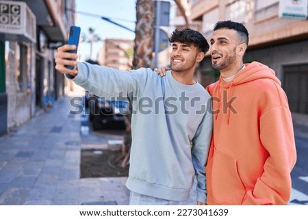 Two man couple making selfie by smartphone at street
