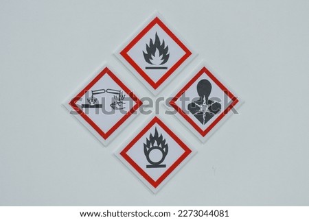 Warning signs in workplaces containing hazardous chemicals and flammable materials.