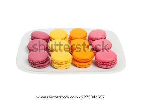 Selection of macarons on a plate isolated against white
