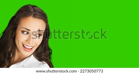 Happy excted smiling woman in white confident cloth looking aside. Business advertisement concept. Brunette businesswoman, isolated green chroma key background. Royalty-Free Stock Photo #2273050773