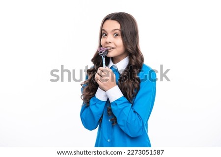 Funny child with lollipop over white isolated background. Sweet childhood life. Teen girl with yummy caramel lollipop, candy shop. Teenager with sweet sucker.