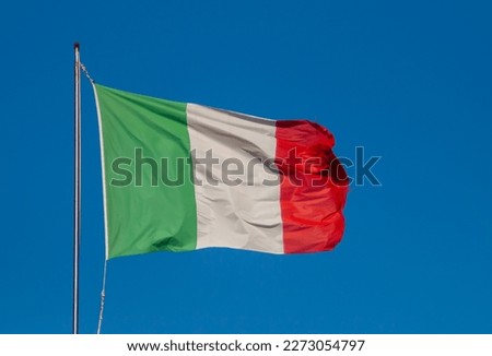Flag of Italy blowing in the wind in Gallipoli, Italy. Flag with a blue sky in the background on a bright summer day.