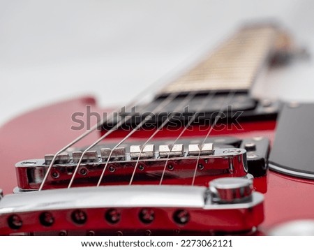 Red electric guitar isolated on white background. Musical instrument guitar. Close-up.