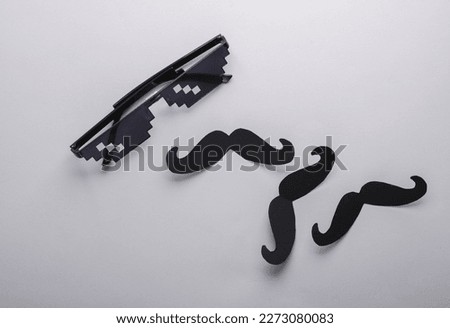 Face from pixel glasses with a mustache on gray background. Creative layout. Father's Day.