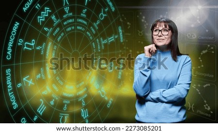 Dreaming happy woman looking at astrological forecast horoscope.
