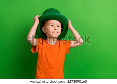 Photo of adorable schoolboy wear leprechaun costume enjoy family saint patrick event isolated on green color background