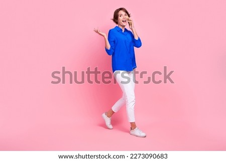 Full body length photo of entrepreneur girl wear blue shirt white pants talking conversation phone important tasks isolated on pink color background