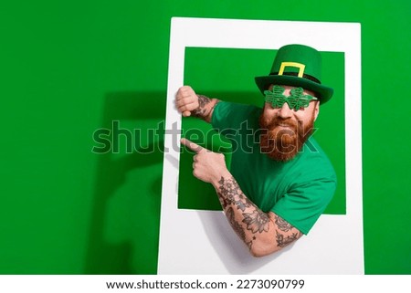 Photo of funky positive man wear t-shirt enjoying shamrock day tacking photography empty space isolated green color background