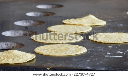homemade tortillas baking on the griddle