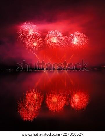 Beautiful red fireworks reflecting in water