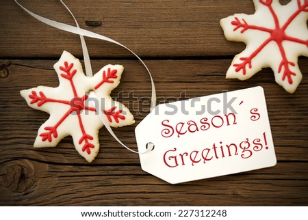 Red and white Christmas Star Cookies with Label on which stands Seasons Greetings