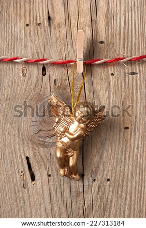 Christmas decoration hanging on clothesline on old wooden background