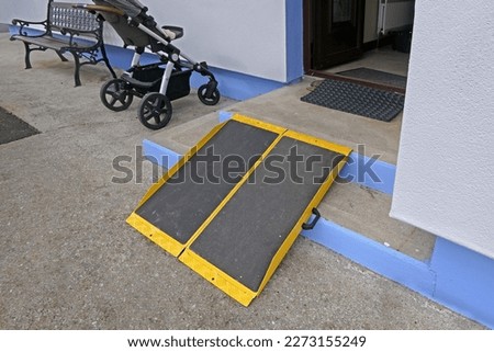 Portable foldable Wheelchair Ramp to the front of a building 