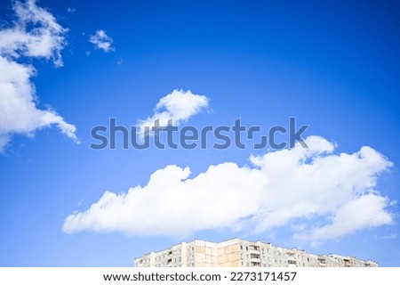 Blue sky with white clouds. Bright sunny day. Cumulus clouds high in the azure sky, beautiful view of the cloudy landscape.