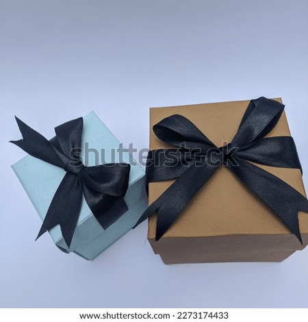 blue and brown gift boxes have bows visible from above