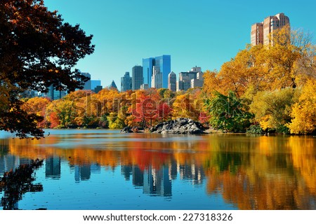 Central Park Autumn and buildings reflection in midtown Manhattan New York City Royalty-Free Stock Photo #227318326