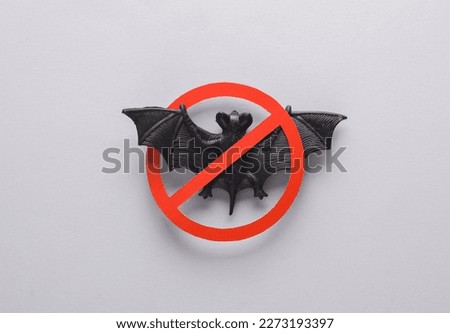 Bat with a prohibition sign on a gray background. Coronavirus causative agent. Let's stop covid 19