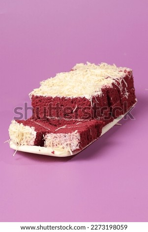Red Velvet Sponge Bread on a long plate with a pink background