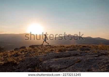 silhouette of a running man against the background of the sky and sunset in the mountains, sports and recreation.sport and health.