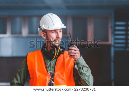 Contractor coworkers working together on remodeling home, Hold a radio to command subordinates.