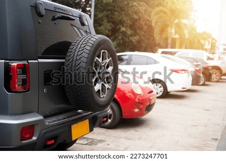 Car spare tire, spare wheel or off-road rear tire Parked in a shopping mall in Laos, Asia Royalty-Free Stock Photo #2273247701