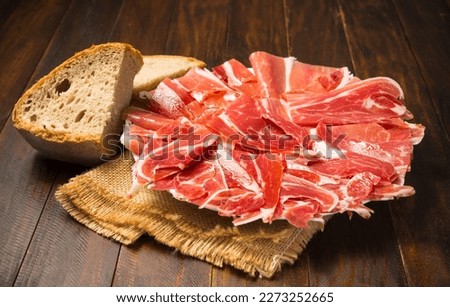 Typical Spanish appetizer, Iberian ham Royalty-Free Stock Photo #2273252665