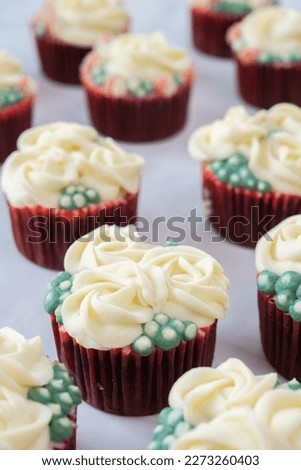 Cup cake decorated with rose cream vertical close up