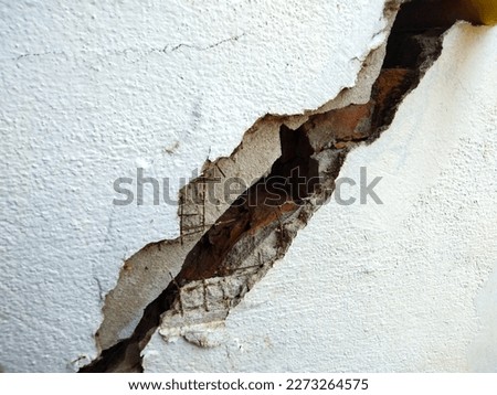 cracked concrete wall  the impact of landslides, earthquakes, geology, low-standard construction Royalty-Free Stock Photo #2273264575