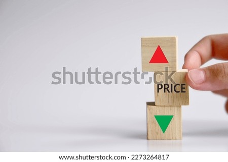 Price level symbol. A wooden cube with up icon. Wooden block with the concept word Price. Beautiful grey table grey background. Copy space