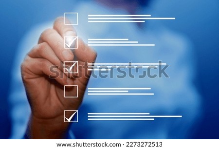 Survey form, check marks on checklist, filling online form and answering questions concept.                               Royalty-Free Stock Photo #2273272513