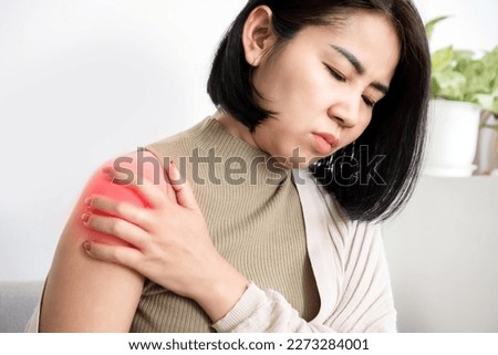 Asian woman suffering from frozen shoulder with pain and stiffness, Rotator cuff tear concept  Royalty-Free Stock Photo #2273284001