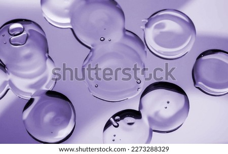 Cosmetic purple lotion transparent gel drops texture background