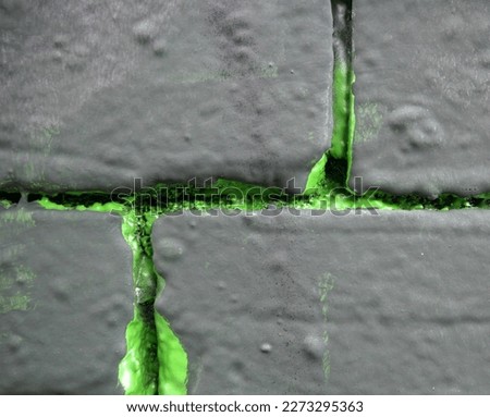 green painted joints of a stone wall