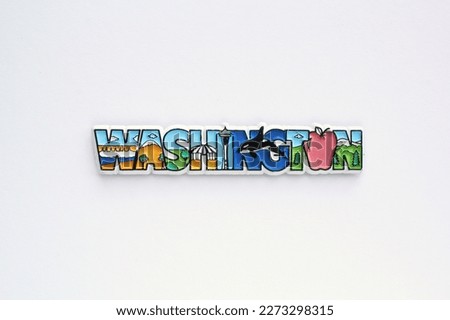 Colourful PVC souvenir fridge magnet of Washington, USA on white background. Travel memory concept. Gift typical product for tourists from foreign trip. Home decoration. Top view, flat lay, close up