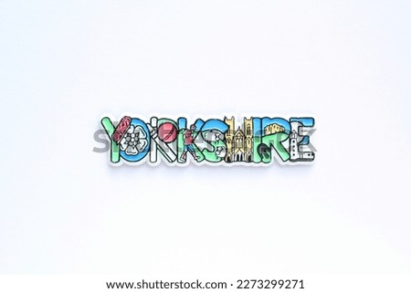 Colourful PVC souvenir fridge magnet of Yorkshire, England on white background. Travel memory concept. Gift typical product for tourists from foreign trip. Home decoration. Top view, flatlay, close up