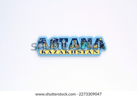 Colourful PVC souvenir fridge magnet of Astana, Kazakhstan on white background. Travel memory concept. Gift typical product for tourists from foreign trip. Home decoration. Top view, flatlay, close up